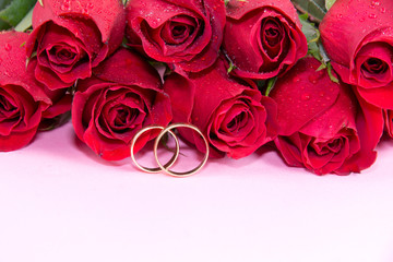 Wedding concept with roses and wedding rings