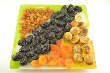 Various dried fruit in a bowl isolated on a white background.