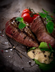 Grilled bbq steaks with fresh herbs and tomatoes