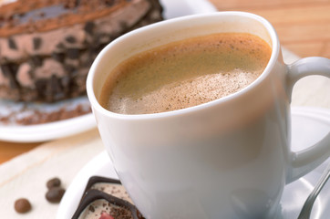 Coffee cup with chocolate dessert cake  aside