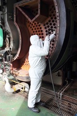 An engineer wearing ppe for an industrial boiler clean
