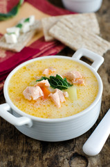 Cheese soup with vegetables and salmon