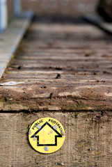 Public footpath sign on wooden walkway