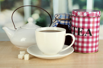 Jar and cup of tea isolated on white