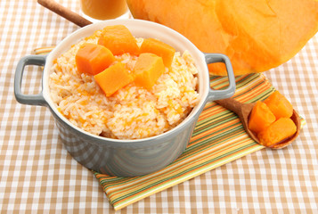 Taste rice porridge with pumpkin in saucepan