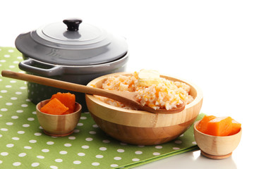 Taste rice porridge with pumpkin, isolated on white.