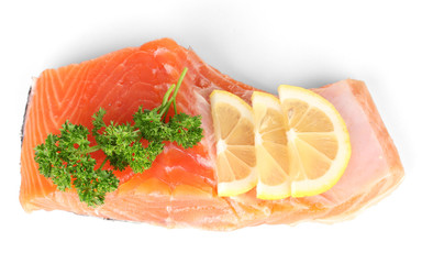 Fresh salmon fillet with herbals and lemon slices, isolated