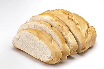 classic French loaf of bread, sliced​​, isolated on white