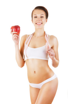 healthy attractive girl with tapemeasure and apple