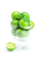 lime in a glass cup and mint isolated on white