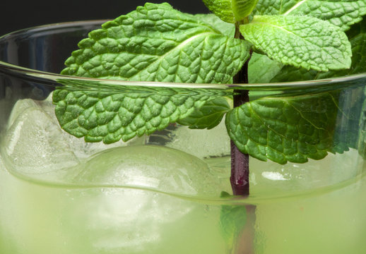 Green cocktail with cubes ice