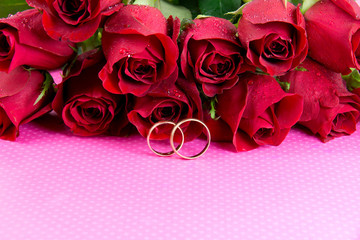 Wedding concept with roses and wedding rings