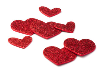 Red shiny hearts on white background