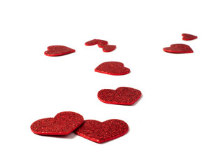 Red shiny hearts on white background