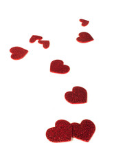 Red shiny hearts on white background