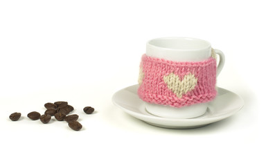 Cup of coffee with knitted heart symbol