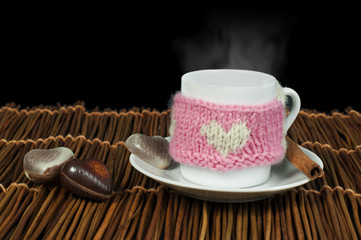 Cup of coffee with knitted heart symbol