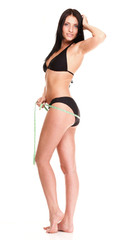 brunette girl bikini measuring waistline tape