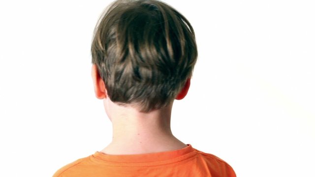 Little boy looks and turn around isolated