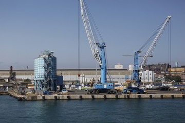 Fototapeta na wymiar Big steel factory with harbor at the Italian coast