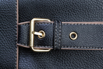 Belt buckles and textured black leather.