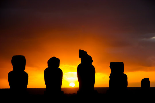 Several moai at Tahai on Easter Island during sunset