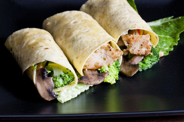 tortilla filled with chicken meat and vegetables