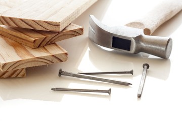 Wood planks with hammer and nails on white background
