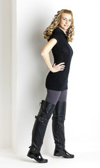 standing woman wearing black clothes and black boots