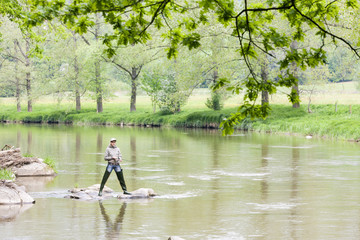 woman fishing in Sazava river, Czech Republic