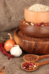 Raw wheat,buckwheat and beans in wooden bowls