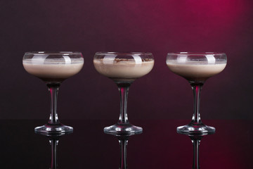 Cream cocktails on dark purple background