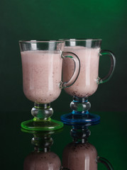 Cream cocktails on dark green background