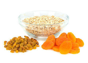 Fototapeta na wymiar oatmeal in a glass bowl and dried fruits