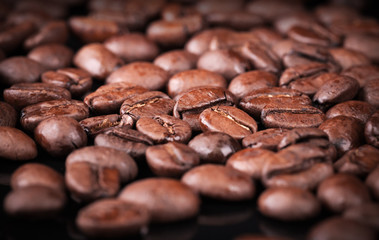 Fresh roasted coffee beans on black table