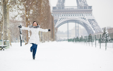 Winter in Paris. Happy young girl jumping