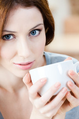 Woman with cup of tea has a rest at the cafeteria