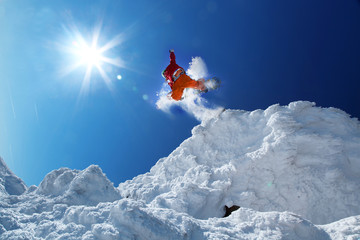 Naklejka na ściany i meble Snowboarder jumping przeciw błękitne niebo
