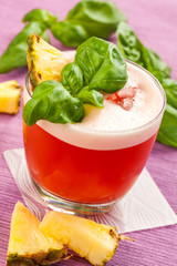Red drink with pineapple