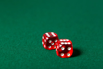 Two red dices on the poker table