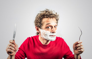 hungry man in the foam with a knife and fork