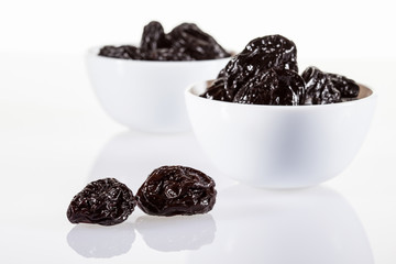 Prunes in white bowls