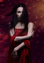 Beautiful vampire woman in red dress