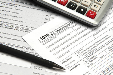 Fototapeta premium Desk with financial and tax papers calculator pen