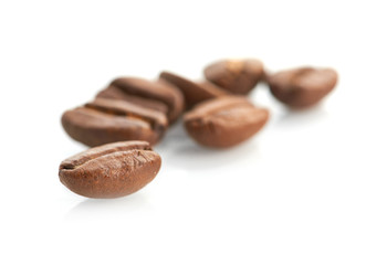 Macro of coffee beans isolated on white background