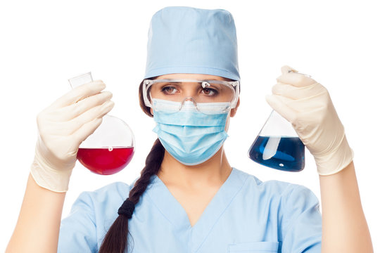 Woman chemist with colored flasks in their hands