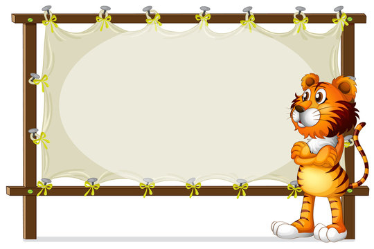 A tiger standing beside a wooden frame