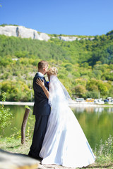 wedding couple in love bride and groom over lake background