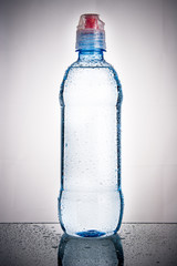 Plastic bottle of drinking water isolated on white