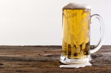 glasses of beers on a wooden table.